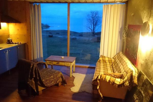 Nina Houses, cozy evening interior view of a straw bale house