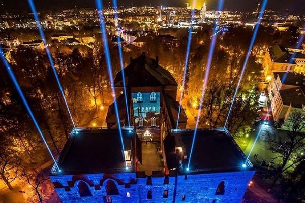 University of Tartu Museum and the spires of the Cathedral during a light festival