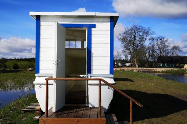 The boat house with an open door invites guests to explore