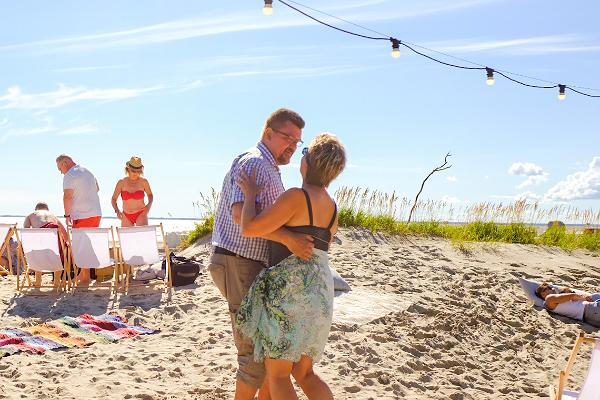 Dancing couple at the beach in summer