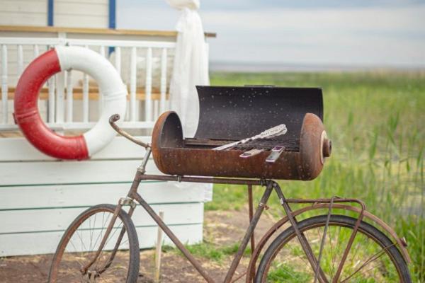 A boat house and a unique bicycle-inspired grill