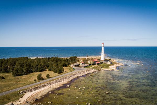 Lighthouse in distance, seaside, blue sky