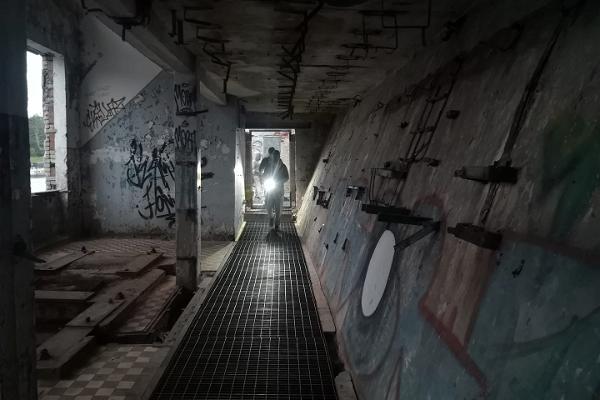 Flashlight adventure – a tour with a guide in dark Soviet era submarine base at Hara