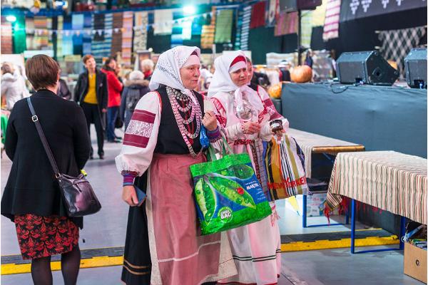 Buyers in traditional clothing at St Martin's Day Fair