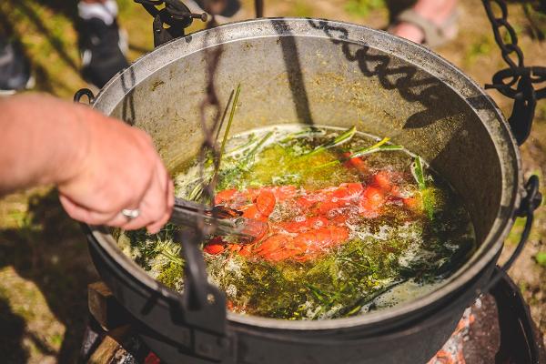 Crayfish soup in the pot cooking over fire