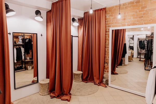 store dressing room with floor to ceiling red curtains and mirrors